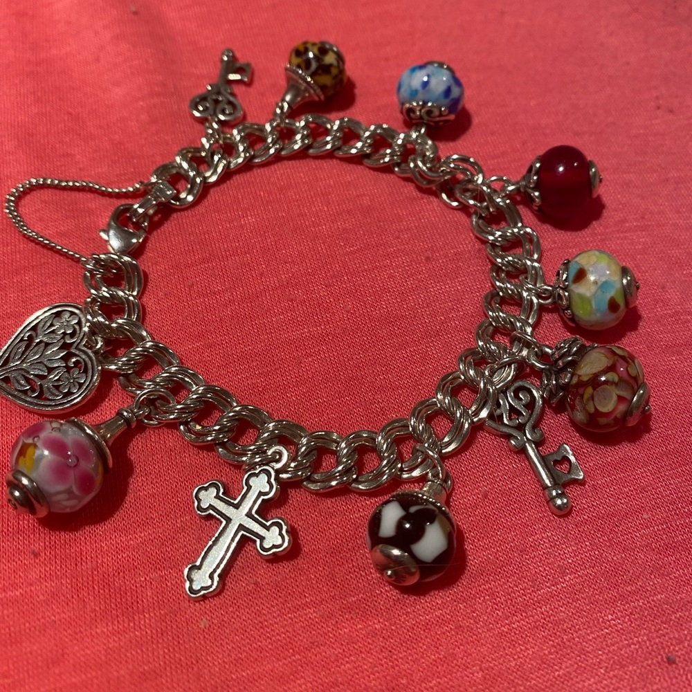 James Avery large silver authentic bracelet with eleven charms. Gently worn.